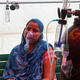 A covid-19 patient breathes with the help of oxygen provided by a Gurdwara, a place of worship for Sikhs, under a tent installed along the roadside in Ghaziabad, India on April 28, 2021.